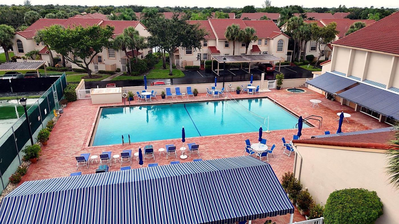 Aerial drone photo of a community pool and clubhouse